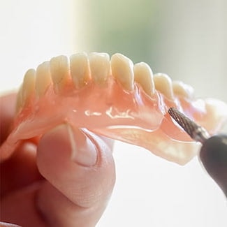 Dentures being cleaned - a part of our restorative dentistry services