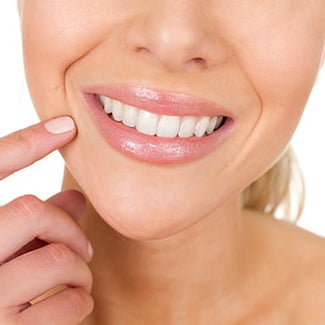 A woman smiling after getting tooth-colored fillings from restorative dentistry